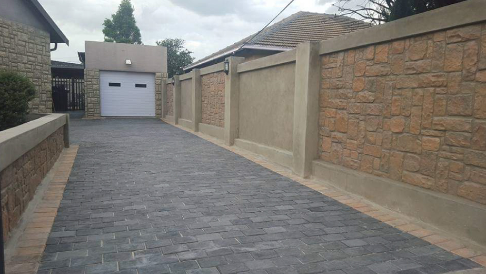 Easy-Edge-Driveway-Paving-Installation-Next-To-Cladded-Wall